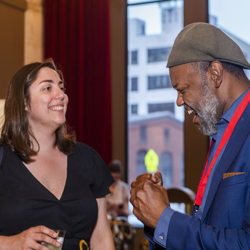 Presenter Godfrey Simmons, Artistic Director at HartBeat Ensemble, speaking with a colleague at the 31st Annual CT Critics Circle Award Ceremony.