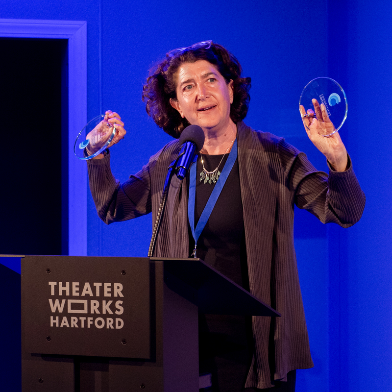 Hartford Stage Artistic Director Melia Bensussen accepting some of the theater's awards.